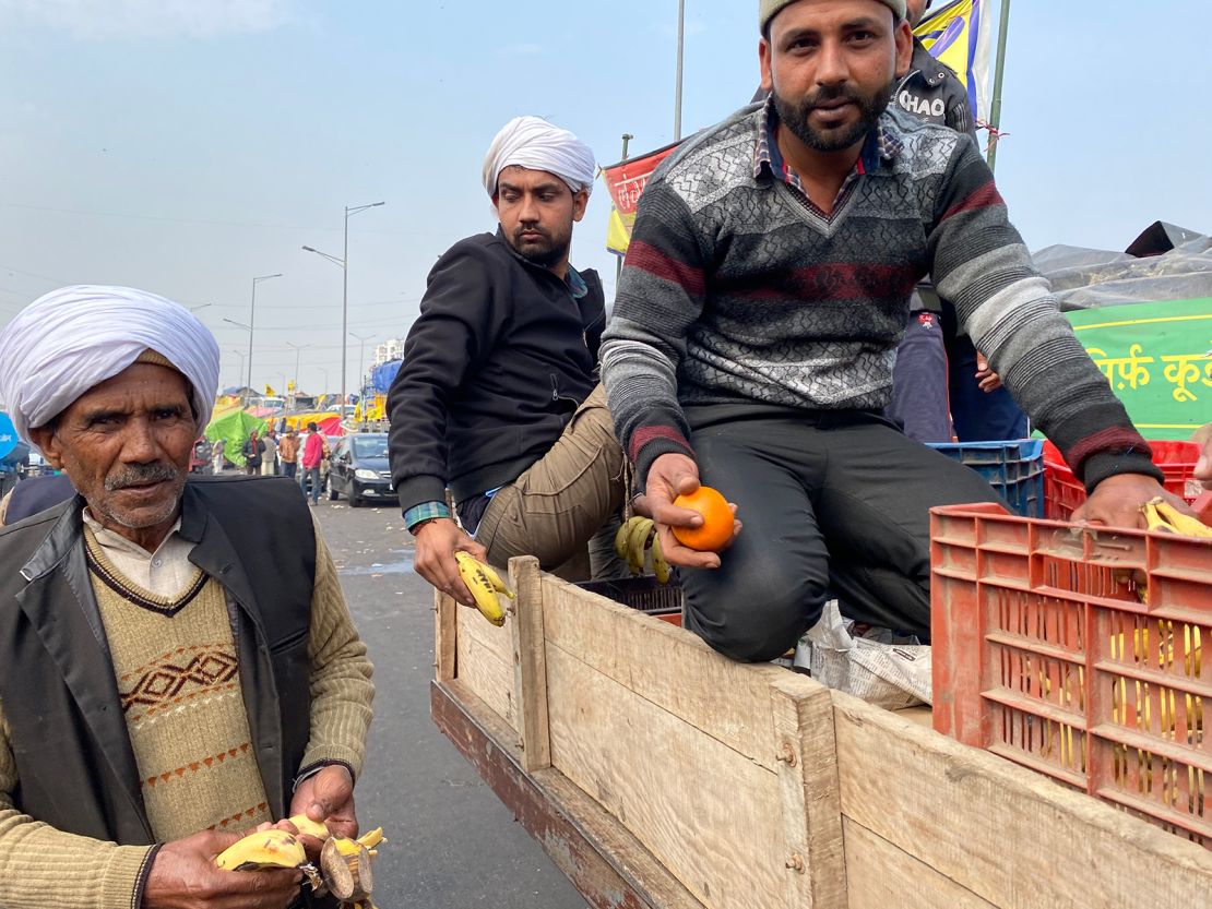 Farmers in Ghazipur gather fresh fruit from the back of a supply truck, on February 4, 2021.