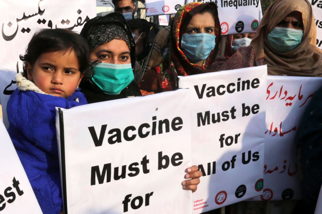 Women hold placards to demand the fair distribution of vaccines during a protest in Lahore, Pakistan, on January 29, 2021.