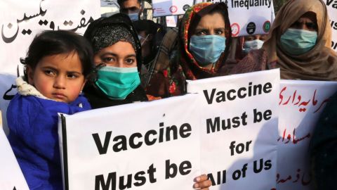 Women hold placards to demand the fair distribution of vaccines during a protest in Lahore, Pakistan, on January 29, 2021.