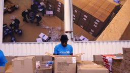 FILE - In this image taken from video on Tuesday Oct. 13, 2020, people work inside the UNICEF warehouse, the world's largest humanitarian aid warehouse, in Copenhagen, Denmark where the groundwork is being laid for the Covax initiative, led by the World Health Organization and the Gavi vaccine alliance. An IBM threat intelligence team said Thursday, Dec. 3 it detected a cyberespionage effort that used targeted phishing emails to try to collect sensitive information from organizations involved in the U.N. initiative for distributing COVID-19 vaccine to developing countries. (AP Photo)