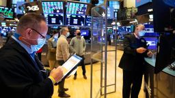 In this photo provided by the New York Stock Exchange, traders gather at a post on the floor, Thursday, Feb. 4, 2021. Stocks moved higher in afternoon trading on Thursday, helped by strong company earnings as well as optimism that Washington can reach a deal for another round of fiscal stimulus for the millions of Americans who need it. (Colin Ziemer/New York Stock Exchange via AP)