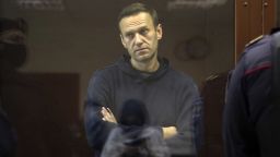 In this image made from video provided by the Babuskinsky District Court, Russian opposition leader Alexei Navalny stands in a cage during a hearing on his charges for defamation, in the Babuskinsky District Court in Moscow, Russia, Friday, Feb. 5, 2021. Navalny was accused of slandering a World War II veteran featured in the video promoting the constitutional reform allowing to extend President Vladimir Putin's rule. The politician slammed people in the video as "corrupt stooges" and "traitors." (Babuskinsky District Court via AP)
