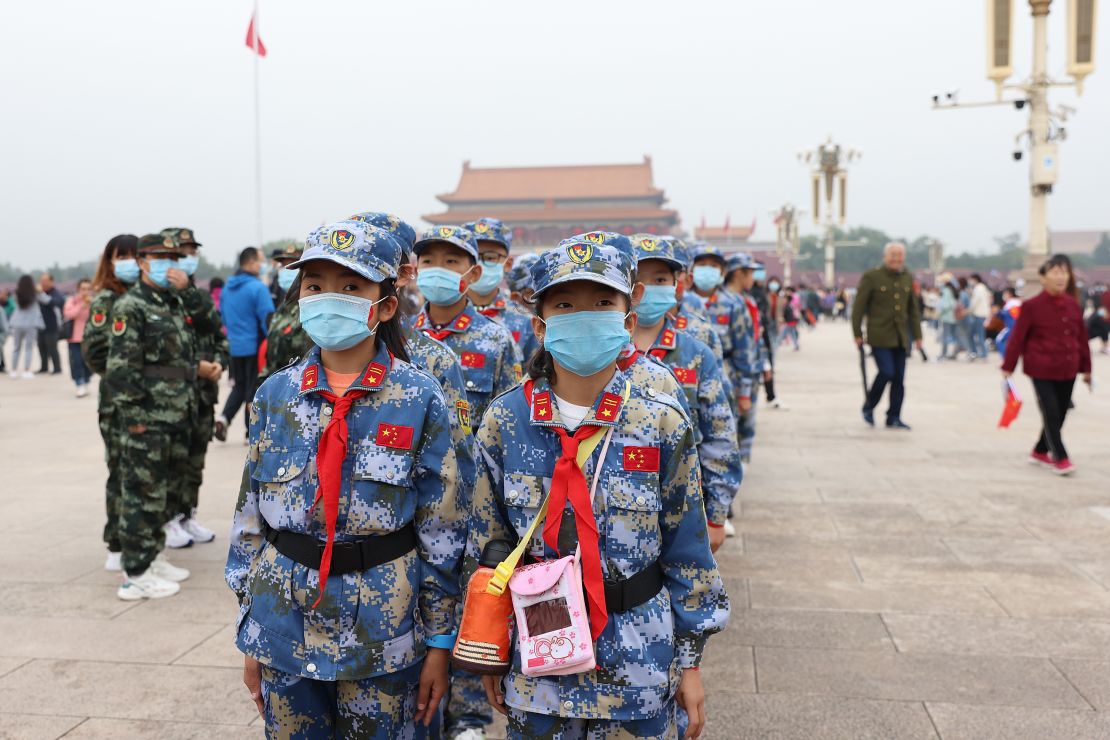 Chinese Young Pioneers wearing face masks take part in a flag-raising ceremony at Tiananmen Square on October 1, 2020 in Beijing, China.