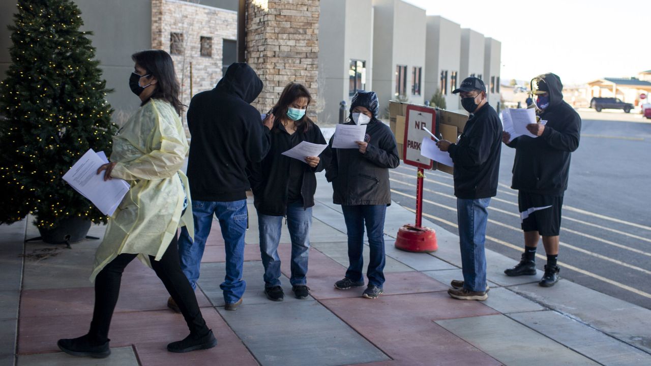 People wait in line at a senior care center on the Navajo Nation in Chinle, Arizona, to receive the Covid-19 vaccine on December 18, 2020.