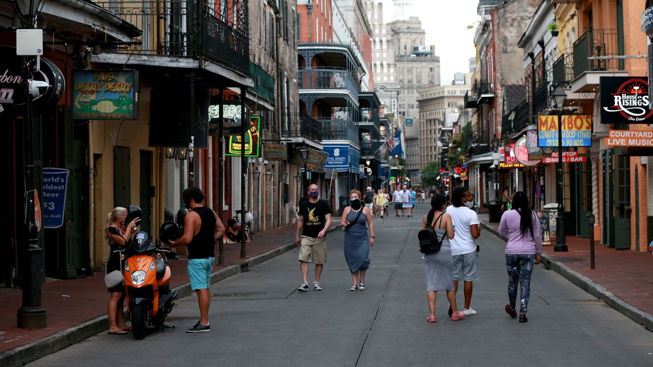 NEW ORLEANS, LOUISIANA - JULY 14:  Pedestrians are seen walking along Bourbon Street in the French Quarter on July 14, 2020 in New Orleans, Louisiana. Louisiana Gov. John Bel Edwards issued three new restrictions for Phase II of reopening that will be in place until at least until July 24 across Louisiana to help prevent the spread of COVID-19. Restrictions include mandatory mask or face covering outside of the home for those eight years old and older, bars will be closed unless providing curbside pickup, and indoor social gatherings are to be limited to 50 people. (Photo by Sean Gardner/Getty Images)