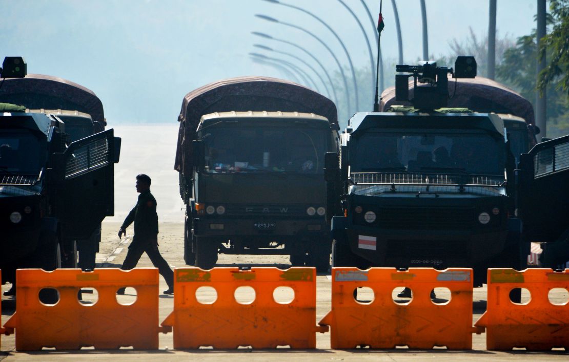 Soldiers stand guard along a blockaded road near Myanmar's Parliament in Naypyidaw on February 2, 2021.