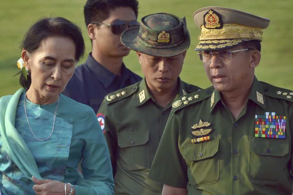 In this May 6, 2016, file photo, Aung San Suu Kyi, left, Myanmar's then foreign minister, walks with Senior Gen. Min Aung Hlaing, right, Myanmar military's commander in chief, in Naypyidaw.