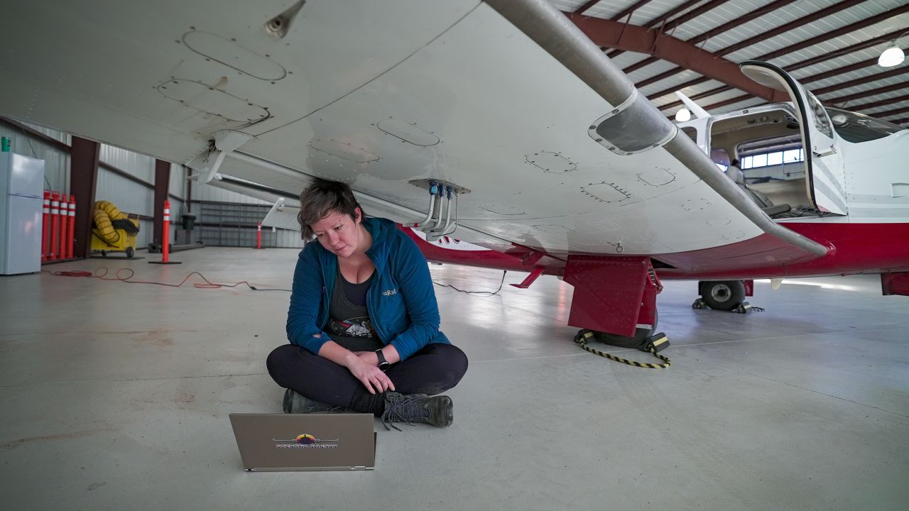 Mackenzie Smith, a senior scientist with Scientific Aviation, checks readings from the instruments that measure gases like methane in the atmosphere. 