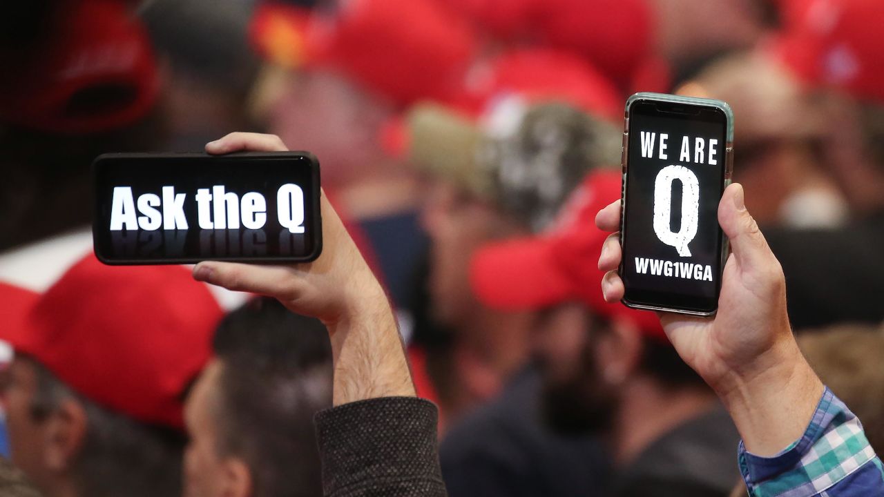 Supporters of President Donald Trump hold up their phones with messages referring to the QAnon conspiracy theory at a campaign rally at Las Vegas Convention Center on February 21, 2020 in Las Vegas, Nevada. 