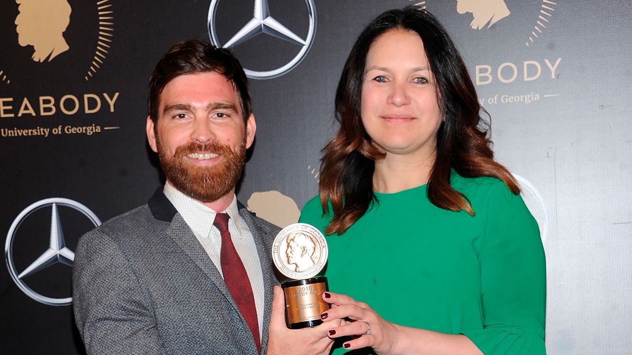 Andy Mills, left, and Rukmini Callimachi hold the award for their 2018 podcast "Caliphate" at the 78th annual Peabody Awards  in New York on May 18, 2019.