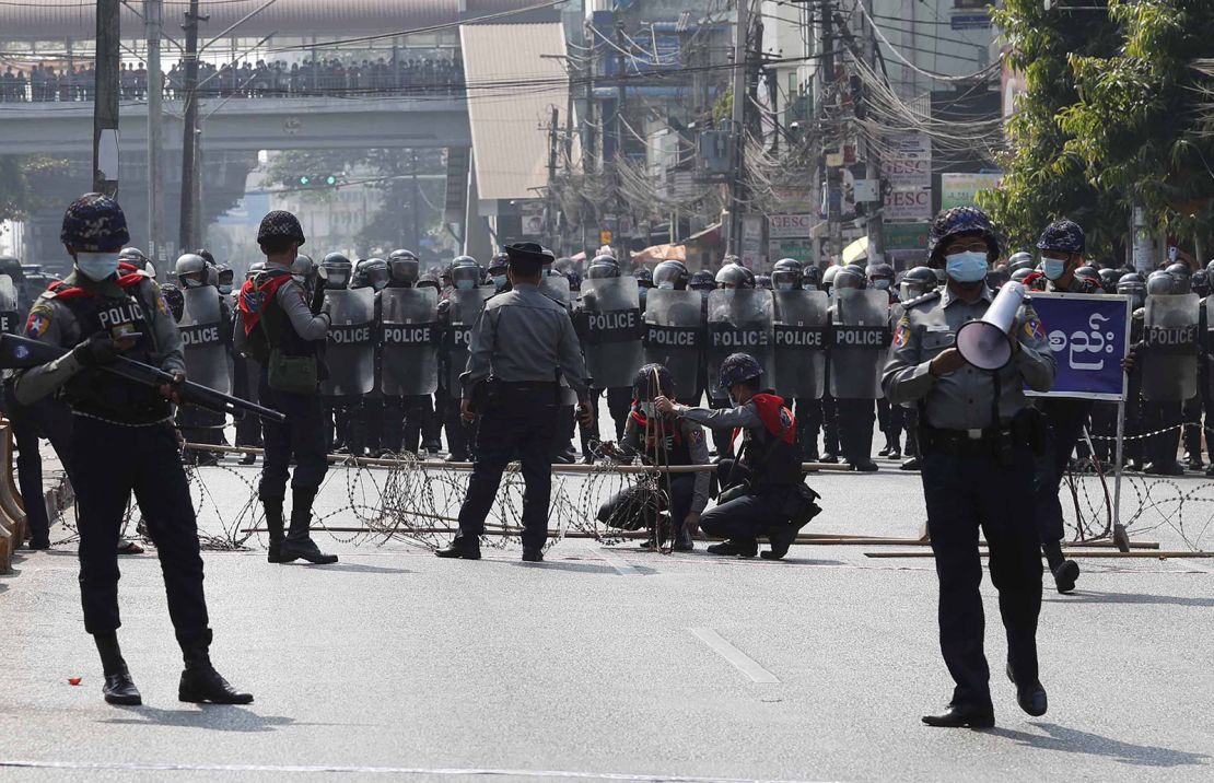 Riot police block a road in Yangon, Myanmar, 06 February 2021.