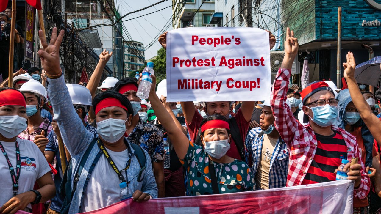 YANGON, MYANMAR - FEBRUARY 06: People make three-finger salutes during an anti-coup march on February 06, 2021 in Yangon, Myanmar. Myanmar's military junta on Saturday placed heavy restrictions on internet connections and suspended more social media services, almost a week after a coup in which it detained de-facto leader Aung San Suu Kyi and charged her with an obscure import-export law violation. Fresh protests broke out on Saturday morning in the country's capital as authorities moved to make mass arrests amid growing civil disobedience. (Photo by Getty Images/Getty Images)