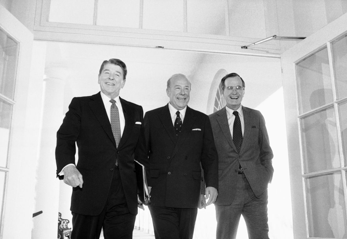 In this Jan. 9, 1985 file photo, Secretary of State George Shultz, center, walks with President Ronald Reagan and Vice President George Bush upon his arrival at the White House in Washington, after two days of arms talks with the Soviet Union in Geneva. (AP Photo/Barry Thumma, File)