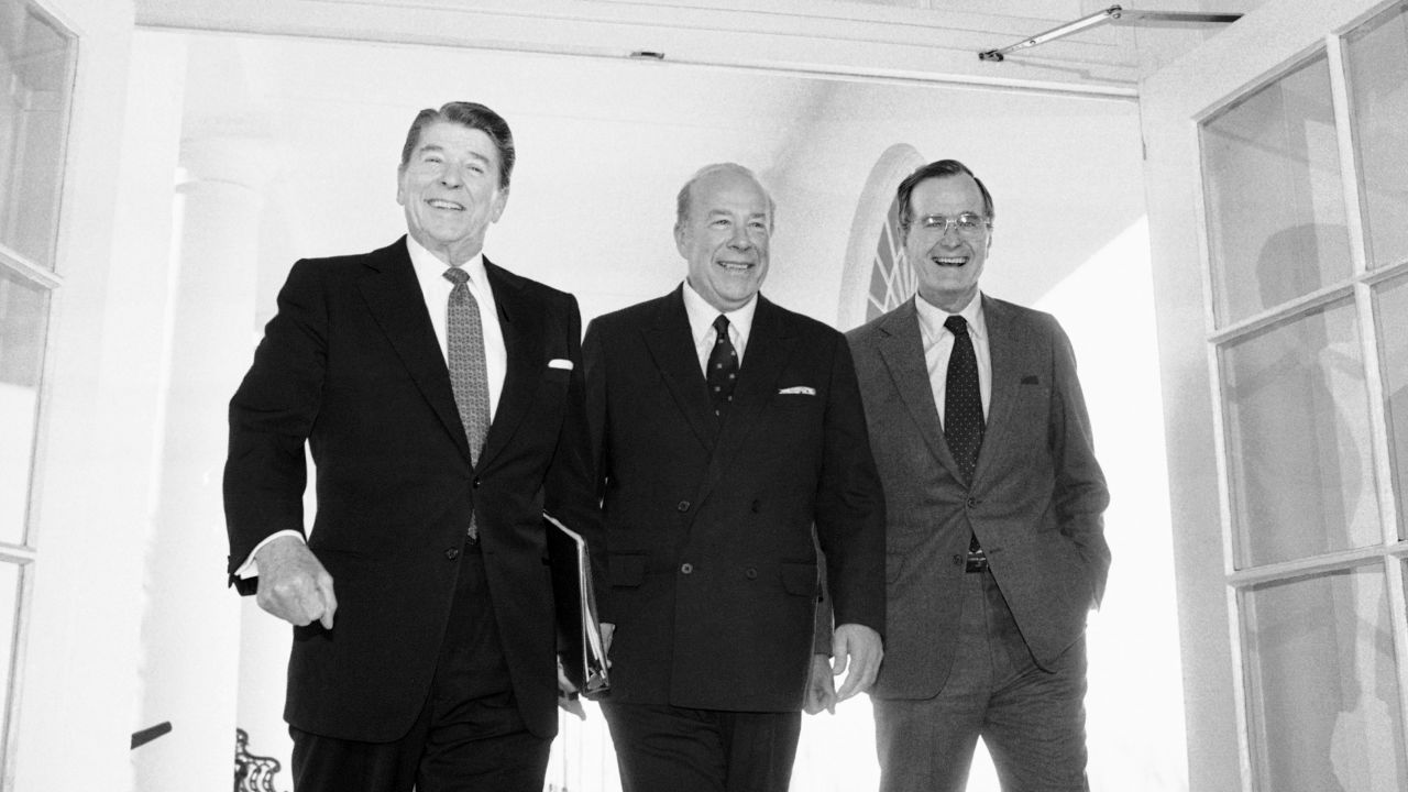 In this Jan. 9, 1985 file photo, Secretary of State George Shultz, center, walks with President Ronald Reagan and Vice President George Bush upon his arrival at the White House in Washington, after two days of arms talks with the Soviet Union in Geneva. (AP Photo/Barry Thumma, File)