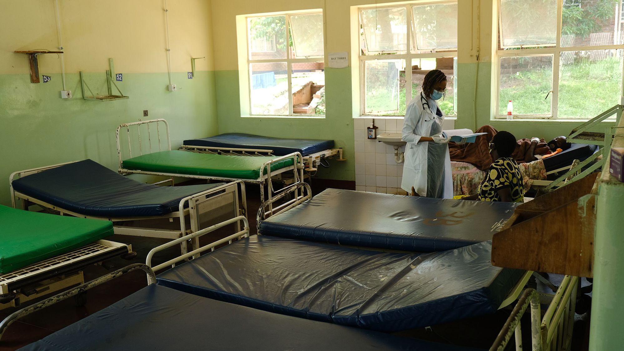 Dr. Tamara Phiri consults with a patient in a general ward. 