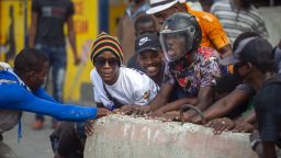 Protesters set up a barricade on a street during a nationwide strike demanding the resignation of Haitian President Jovenel Moise in Port-au-Prince, Haiti, Tuesday, Feb. 2, 2021. (AP Photo/Dieu Nalio Chery)