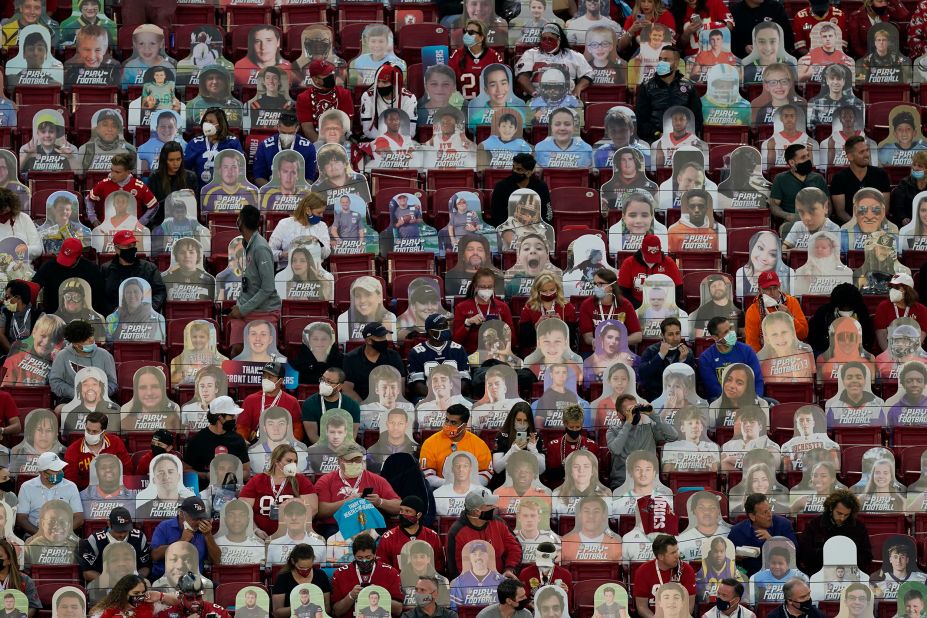 Fans sit among cardboard cutouts before the game.