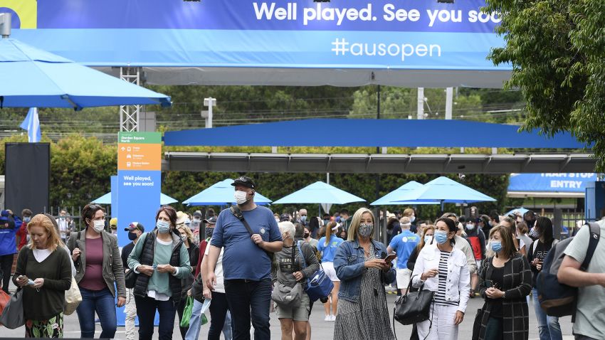 Spectators walk into Melbourne Park ahead of the first round matches at the Australian Open tennis championship in Melbourne, Australia, Monday, Feb. 8, 2021.(AP Photo/Andy Brownbill)