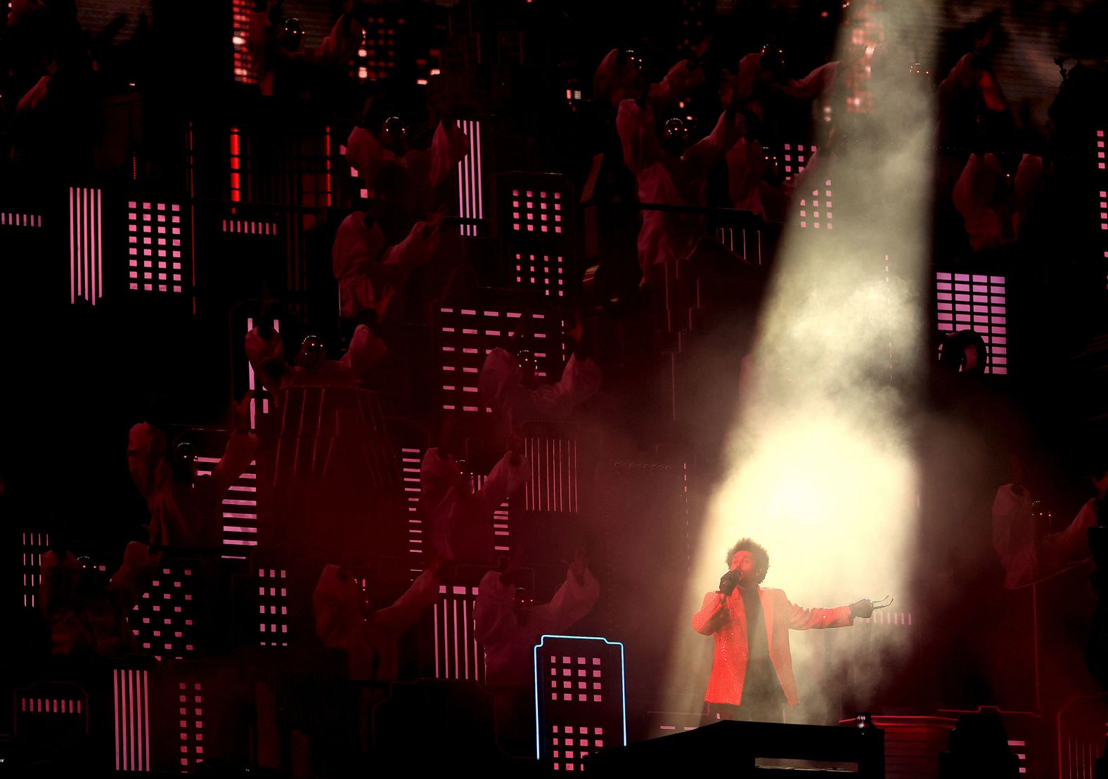 A spotlight shines on The Weeknd during the show.