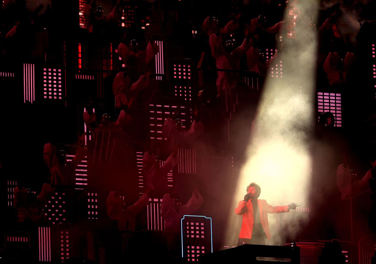 A spotlight shines on The Weeknd during the show.