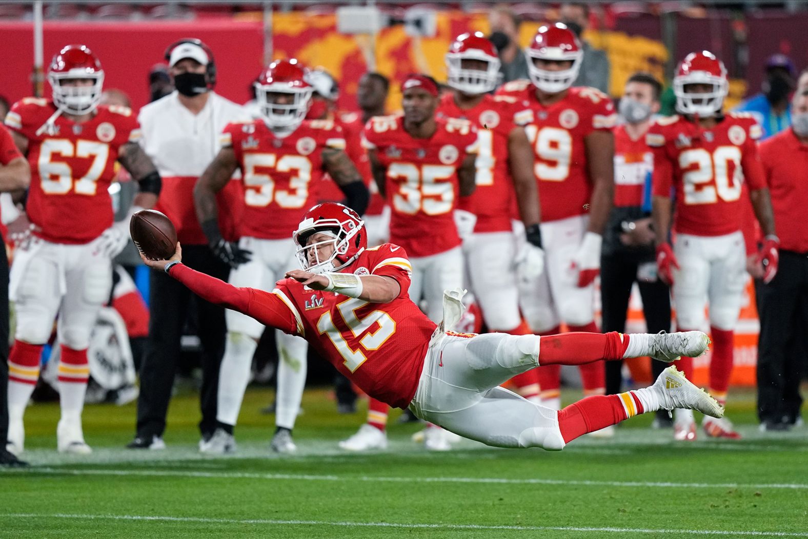 Mahomes attempts a pass while falling down in the second half.