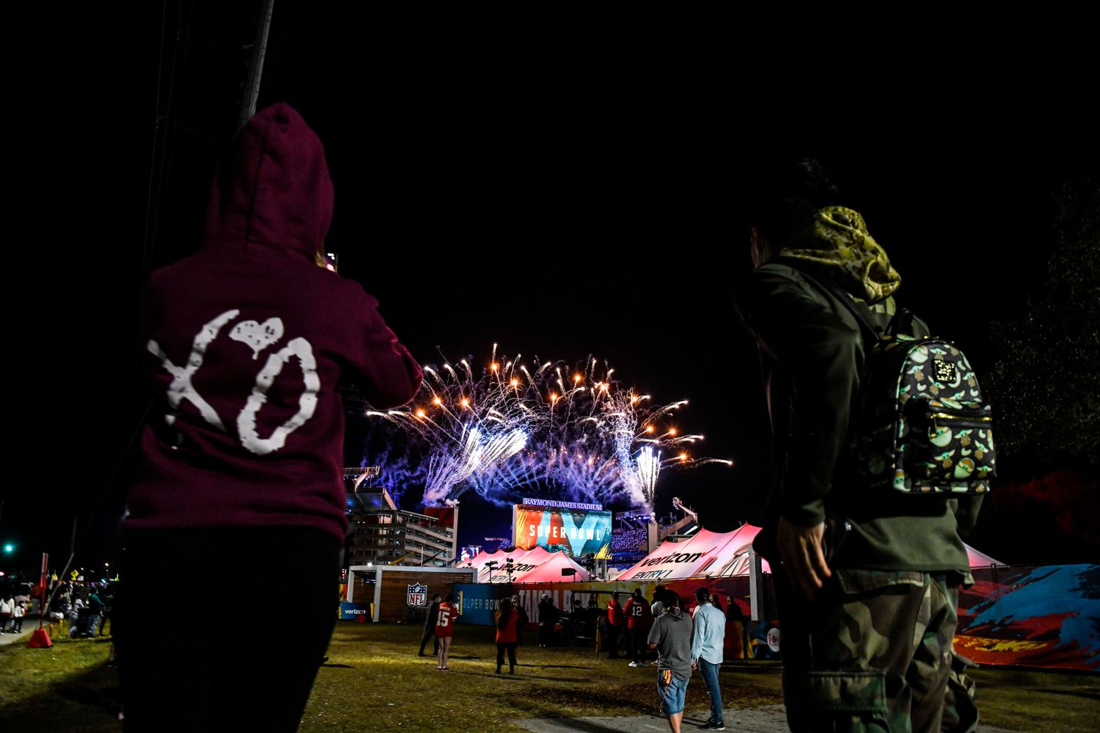 Fans watch postgame fireworks from outside the stadium.