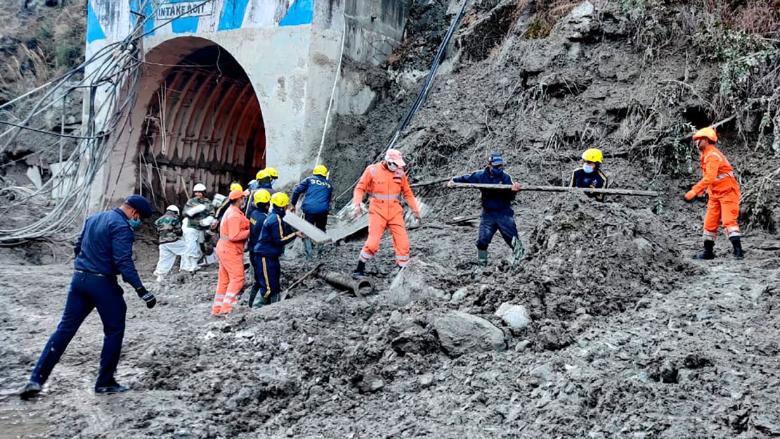 This photograph from the National Disaster Response Force shows NDRF personnel rescuing workers at one of the hydropower projects at Reni village in Chamoli district. 