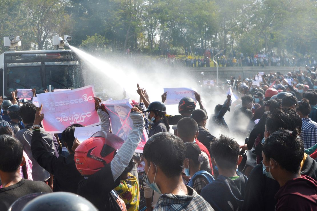 A police vehicle fires water cannon in an attempt to disperse protesters during a demonstration against the military coup in Naypyidaw on February 8, 2021