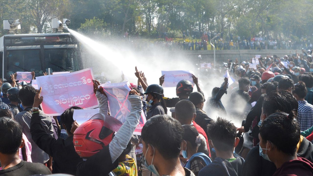 A police vehicle fires water cannon in an attempt to disperse protesters during a demonstration against the military coup in Naypyidaw on February 8, 2021