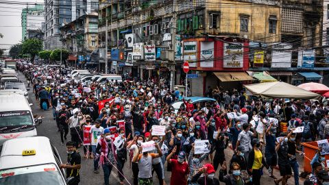 Anti-coup protesters march through a street in Yangon, Myanmar, on February 8, 2021.