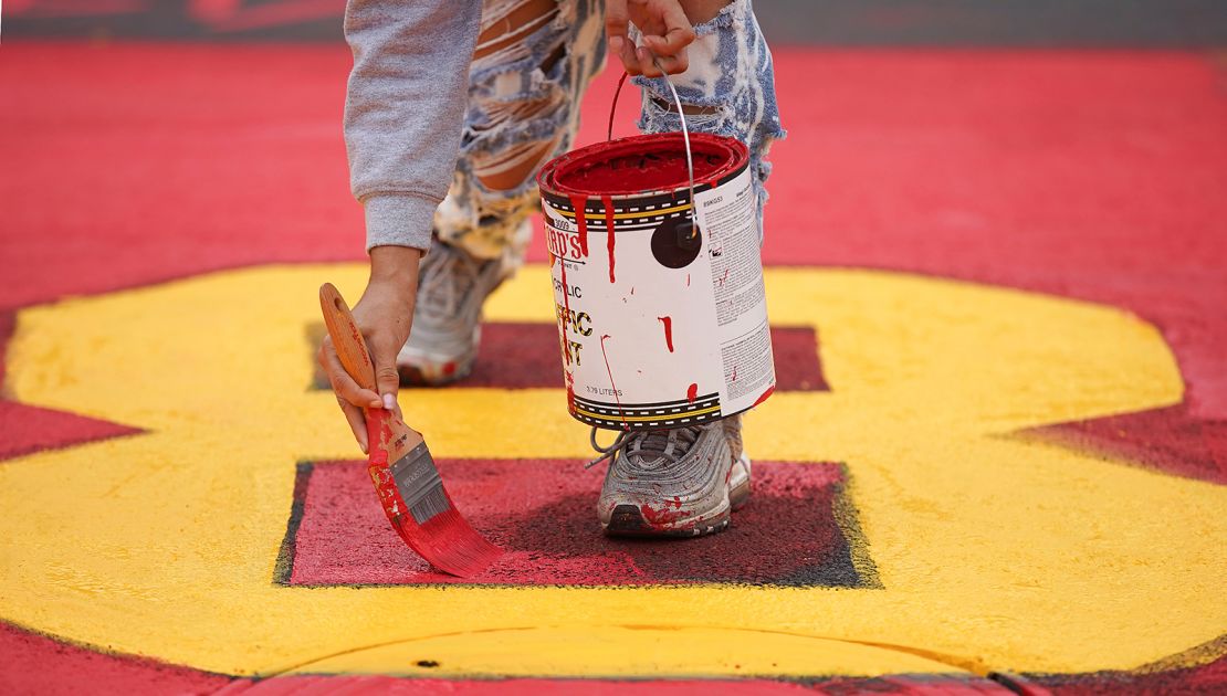 Brittany Torres works on the mural in front of Jack Yates High School in Houston on Saturday, February 6
