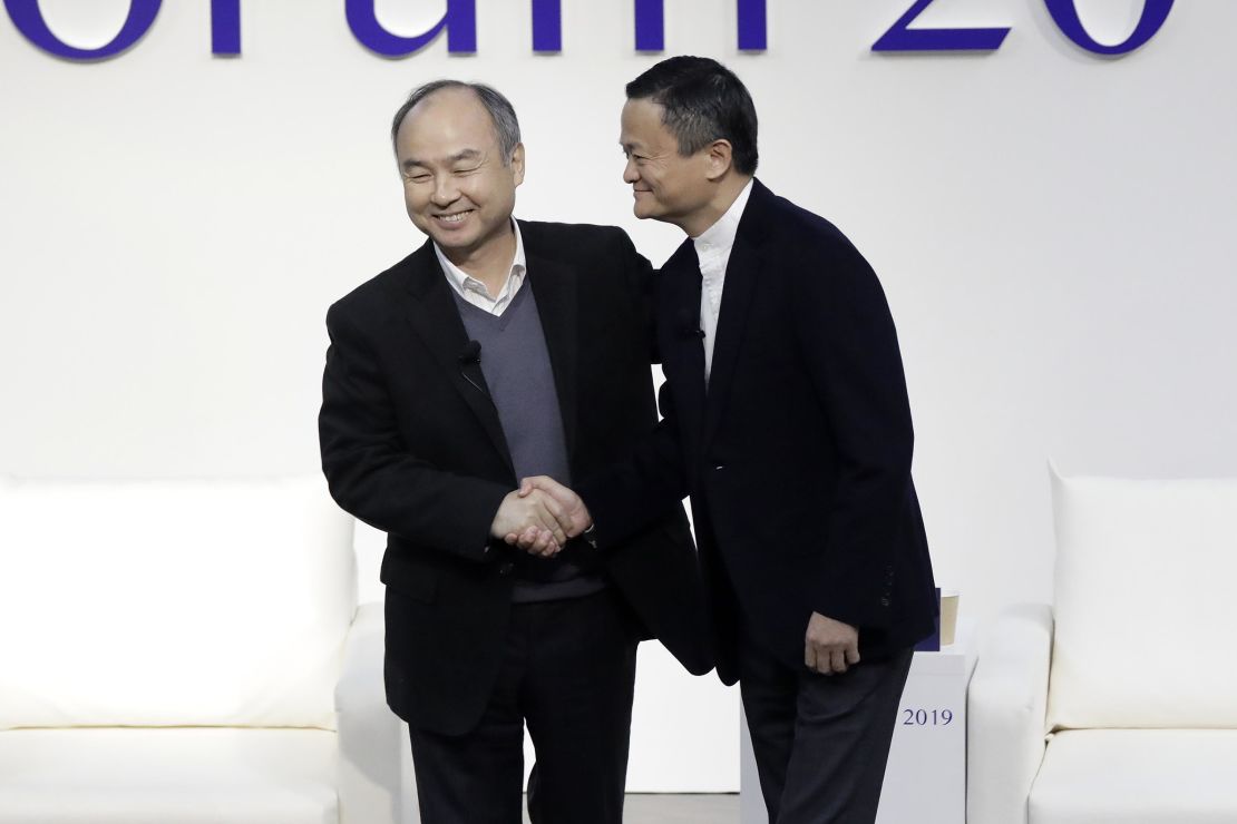 Masayoshi Son and Jack Ma shaking hands at a forum in Tokyo in 2019.