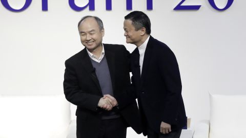 Masayoshi Son and Jack Ma shaking hands at a forum in Tokyo in 2019.