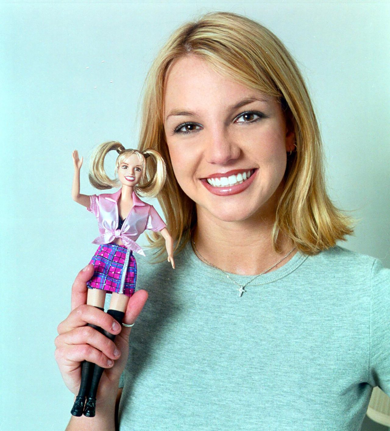 Spears holds a doll of herself in 1999.