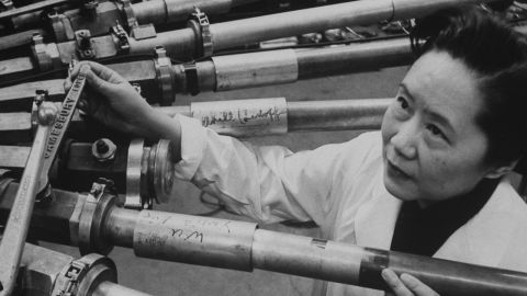 Physicist Chien-Shiung Wu stands beside a particle accelerator at Columbia University, where she worked for decades.