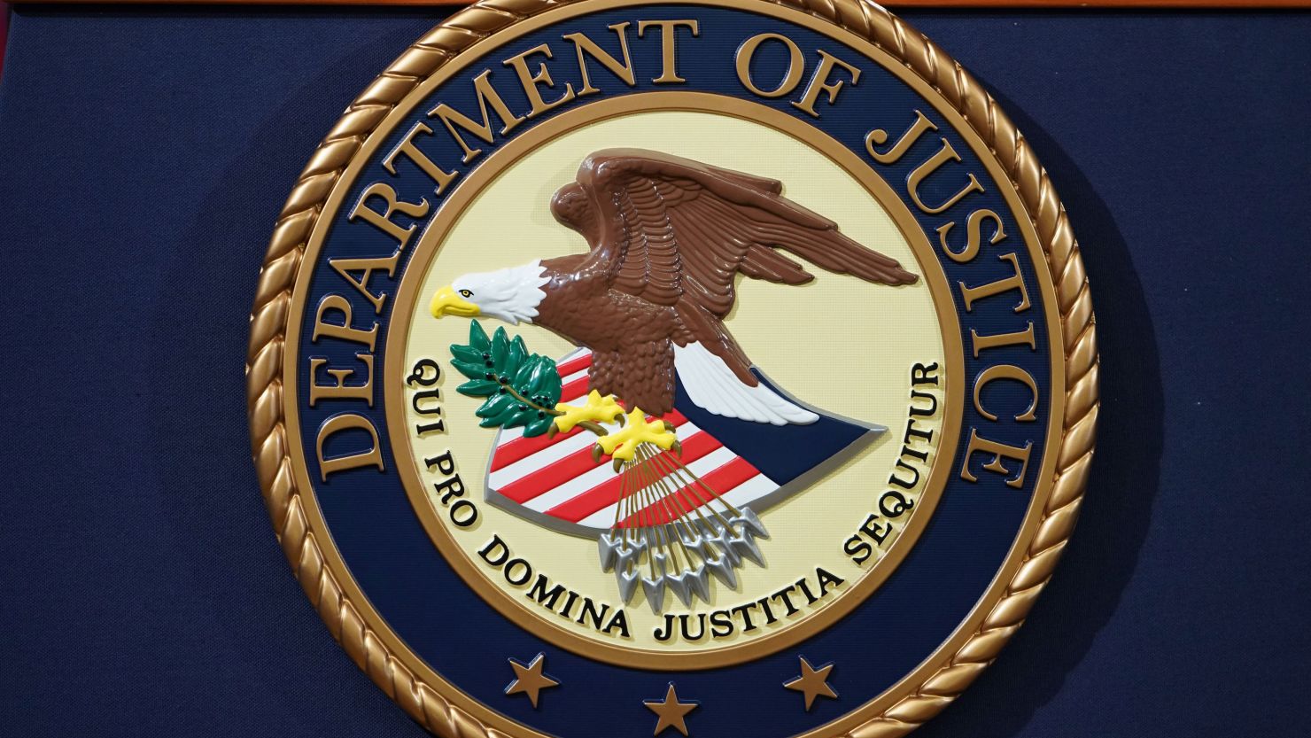 The Department of Justice seal is seen on a lectern ahead of a press conference announcing efforts against computer hacking and extortion at the Department of Justice in Washington, DC on November 28, 2018. (Photo by MANDEL NGAN / AFP) (Photo by MANDEL NGAN/AFP via Getty Images)