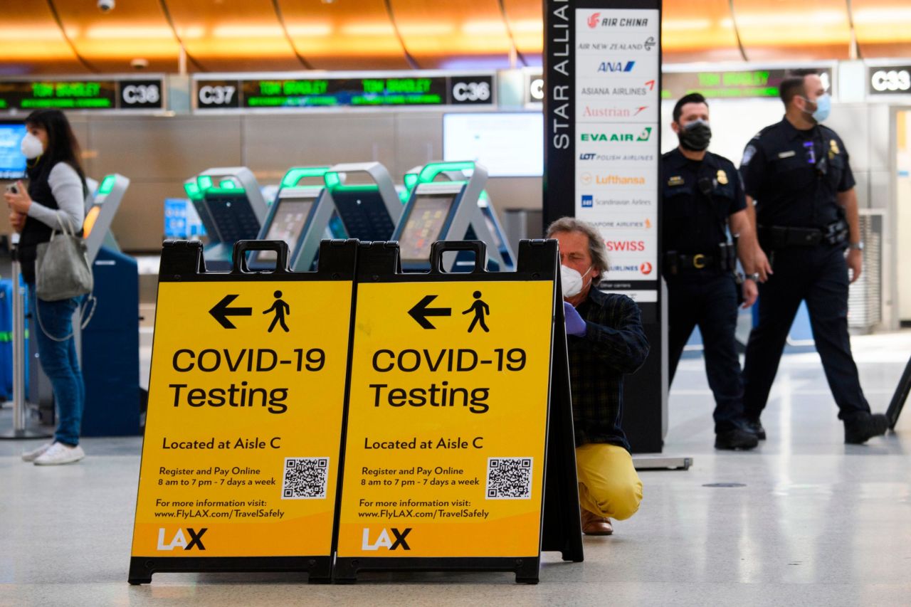 A traveler takes a photo of a Covid-19 testing sign at  Los Angeles International Airport (LAX) in February 2021.
