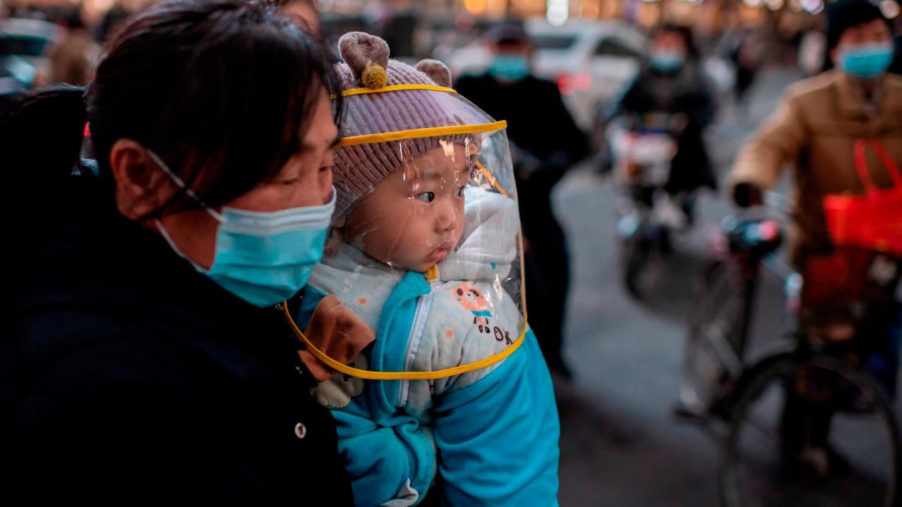 A woman and her baby seen in the Chinese city of Wuhan in January 2021.