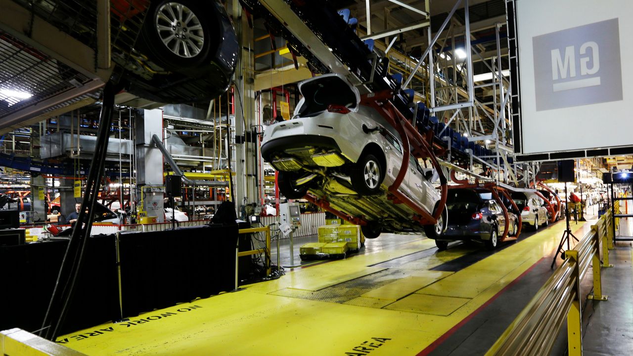 In this Monday, Jan. 28, 2013, file photo, cars move along an assembly line at the General Motors Fairfax plant in Kansas City, Kan. General Motors is extending the normal two-week summer shutdown at two U.S. car factories because of slumping demand. Union officials say the Lordstown, Ohio, plant near Cleveland and the Fairfax plant in Kansas City, Kan., will close for as long as five weeks in June and July 2017. (AP Photo/Orlin Wagner, File)