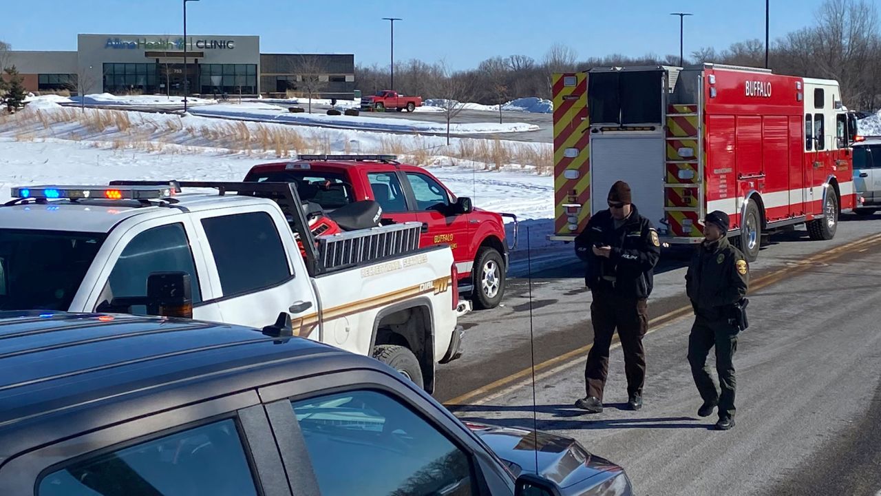 Law enforcement personnel and first responders gather outside of the Allina Health clinic on Tuesday, February 9, 2021, in Buffalo, Minnesota.