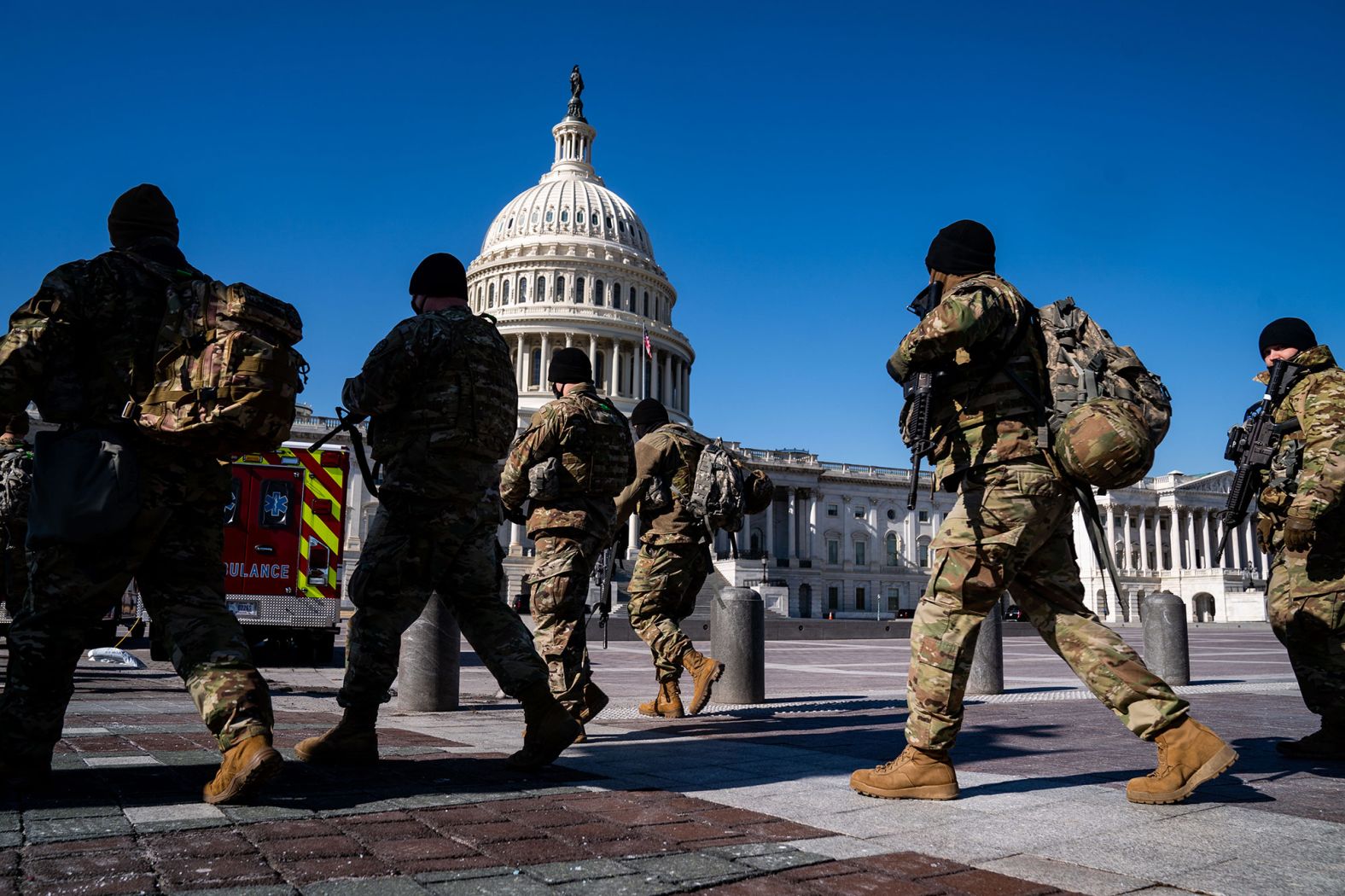 National Guard members walk near the Capitol on Monday, February 8.