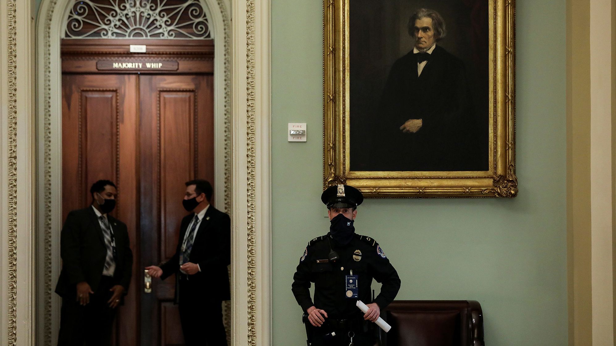 A Capitol Police officer stands watch as senators arrive at the Senate Chamber on Tuesday.