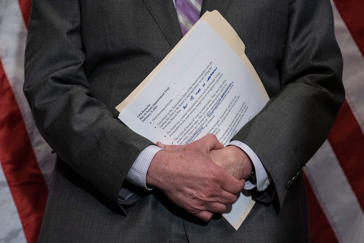 Senate Majority Leader Chuck Schumer holds notes during a news conference at the Capitol on Tuesday.