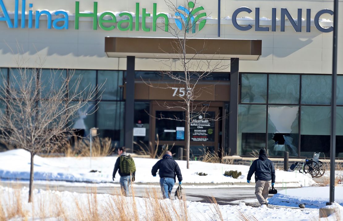 Law enforcement personnel walk toward the Allina Health clinic on Feb. 9, 2021, in Buffalo, Minnesota.