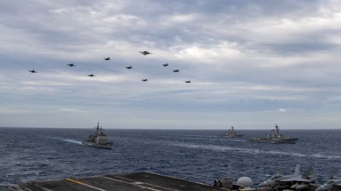 US Navy aircraft fly over the USS Theodore Roosevelt Carrier Strike Group and the USS Nimitz Carrier Strike Group in the South China Sea on February 9, 2021. 
