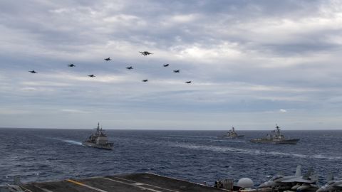 US Navy aircraft fly over the USS Theodore Roosevelt Carrier Strike Group and the USS Nimitz Carrier Strike Group in the South China Sea on February 9, 2021.