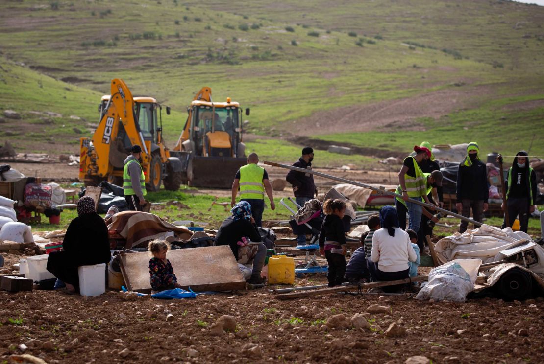 Residents watch Israeli troops demolish tents and other structures in Khirbet Humsa on February 3, 2020. 