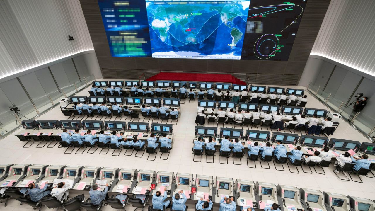 Employees at the Beijing Aerospace Control Center BACC in Beijing, China, on October 9, 2020, after the Tianwen-1 probe successfully conducted a deep-space maneuver.