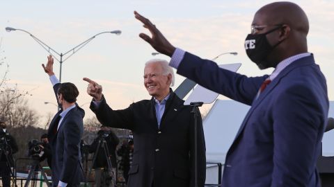 Biden rallies with Democratic candidates for the U.S. Senate Jon Ossoff (L) and Rev. Raphael Warnock (R) the day before their runoff election January 4, 2021 in Atlanta, Georgia.