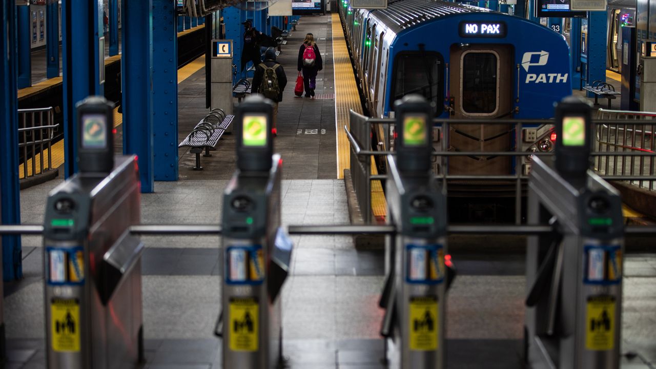 A commuter exits a New Jersey PATH train at a station in the Herald Square area of New York on Tuesday, May 12, 2020.